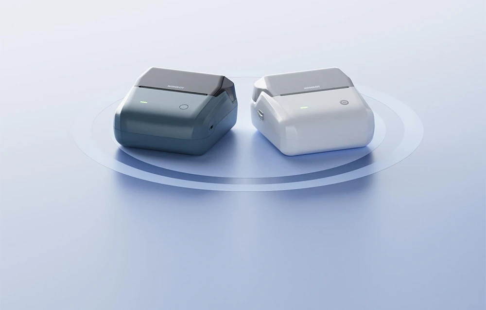 Two NIIMBOT thermal printers in blue and white set against a circular backlit background