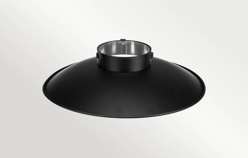 Un reflector fotografic negru, neted, cu un inel metalic de montare vizibil de sus pe un fundal deschis