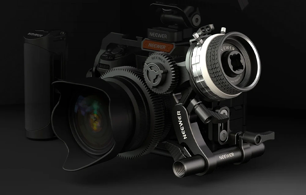 Mecanismul profesional de mini follow focus de la Neewer montat pe obiectivul unei camere într-un mediu întunecat.
