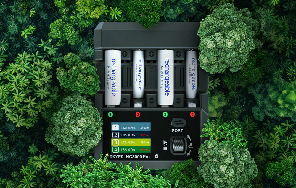 Încărcător SkyRC NC3000 Pro cu baterii înconjurate de vegetație verde.