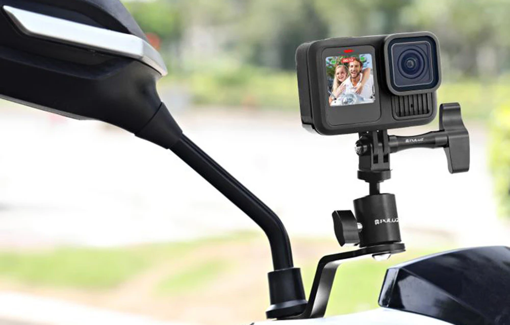 Cameră de acțiune GoPro montată pe oglinda motocicletei cu fundal rutier neclar