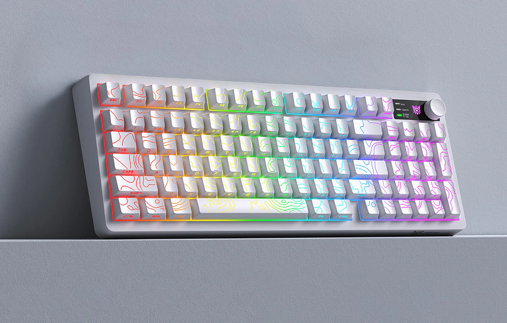 O tastatură albă cu iluminare colorată pe o platformă gri, sprijinită de un perete gri