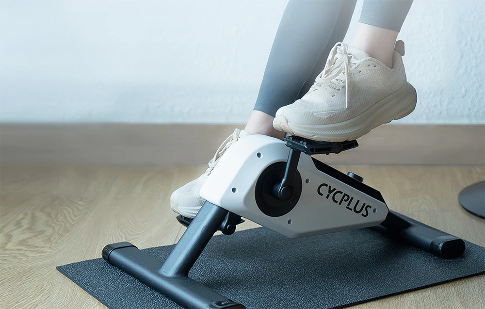 Picioare pedalând pe o mini bicicletă de reabilitare