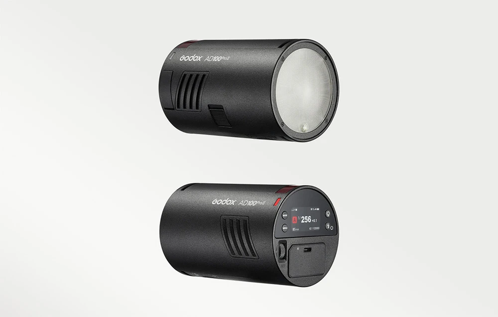 Două unități de bliț Godox AD100Pro II, care prezintă capul rotund în față și panoul de control în spate