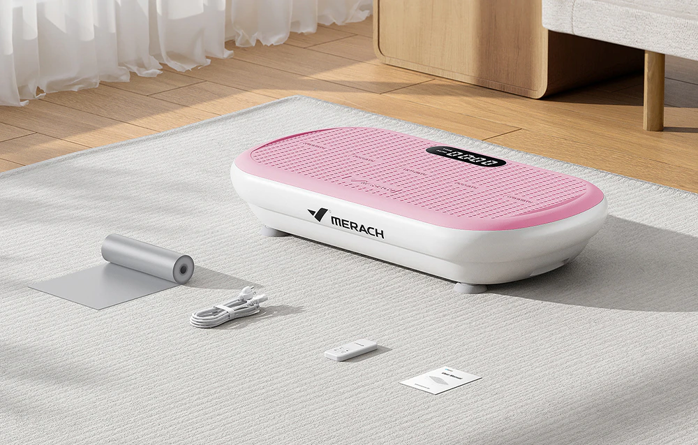 Setul platformei vibratoare Merach cu accesorii pe un covor în sufragerie.