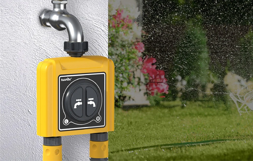 RainPoint irrigation controller mounted to a white plaster wall, with the garden in the background.