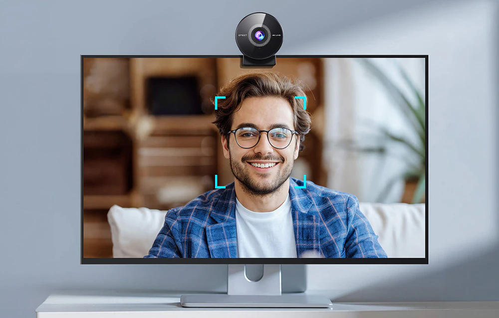 O cameră montată pe ecranul unui computer cu funcția de focalizare automată activă pe fața unui bărbat.