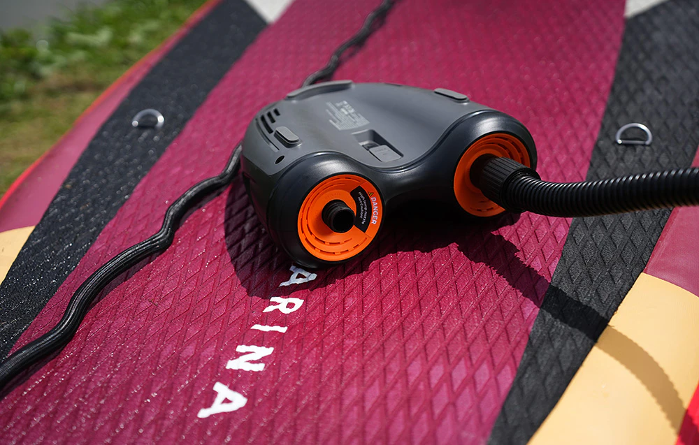 Partea inferioară a pompei Flextail Evo SUP Pump Pro cu furtunul conectat la placa SUP.