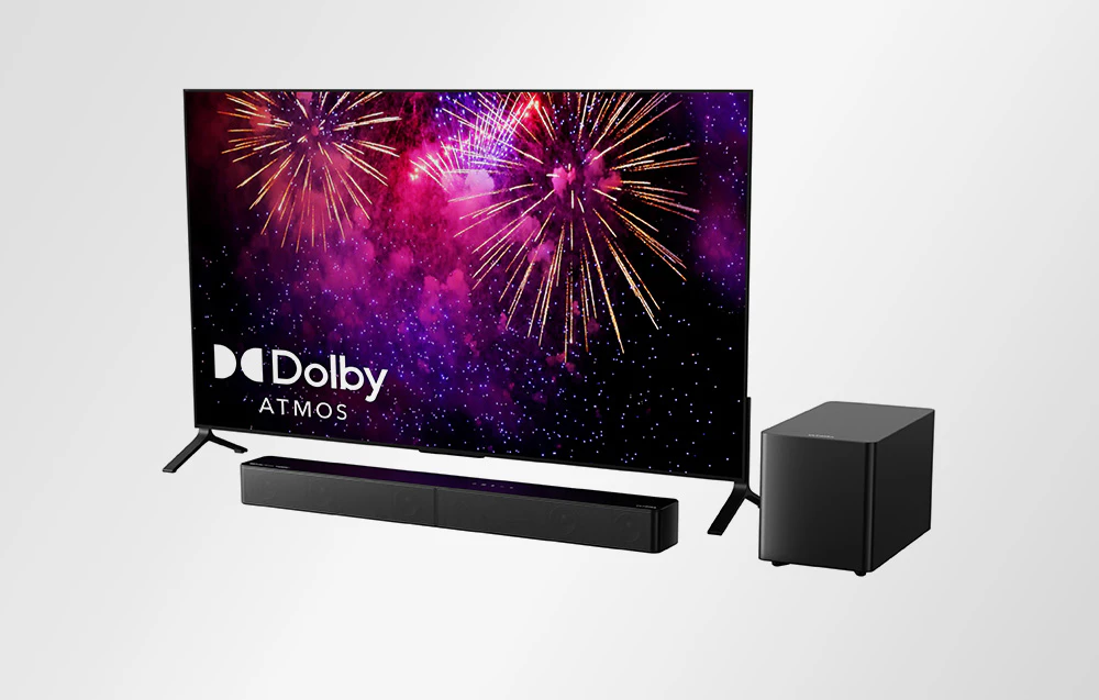 Set Ultimea cu televizor, bară de sunet și subwoofer, afișând artificii cu logo-ul Dolby Atmos