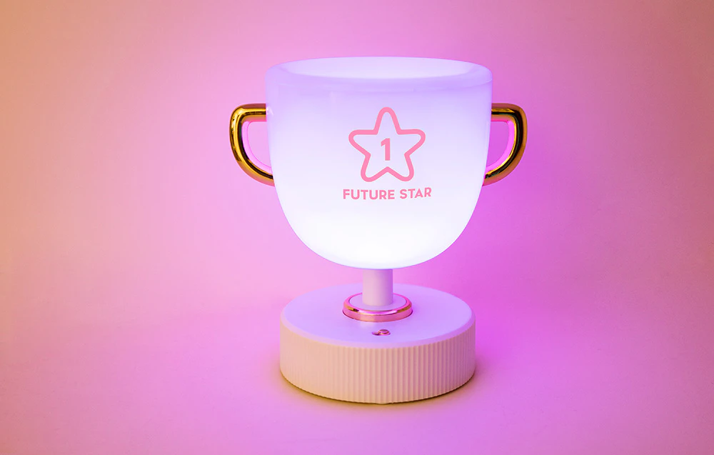 Lumină de noapte pentru copii SuperFire W-006 Champion Light pe fundal roz.
