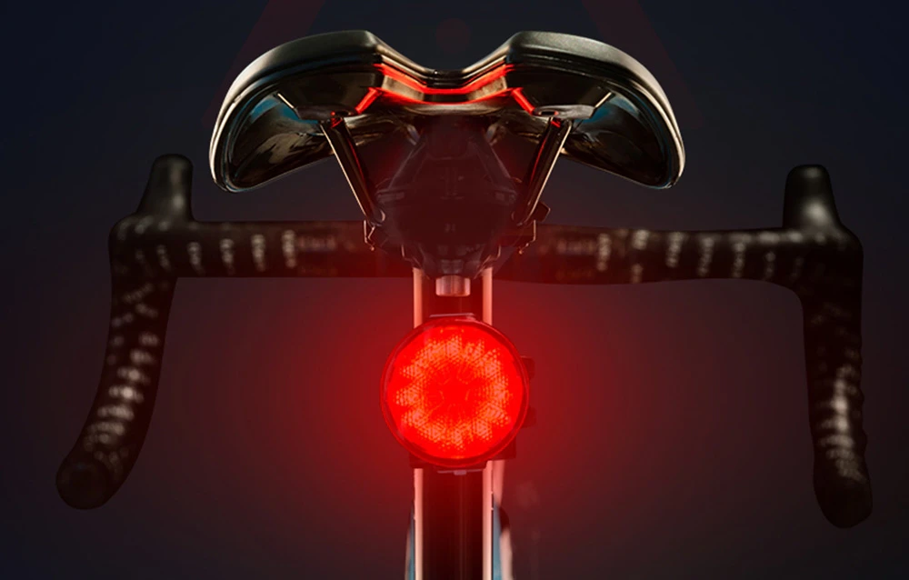 Lumină spate de bicicletă montată sub șa și care strălucește roșu