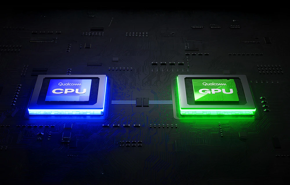 Două cipuri Qualcomm iluminate – CPU (albastru) și GPU (verde) – montate pe o placă de bază